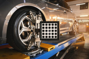Car wheel alignment is in progress. auto camber toe check fixing. sensor during suspension adjustment and automobile wheel alignment work at the repair service station